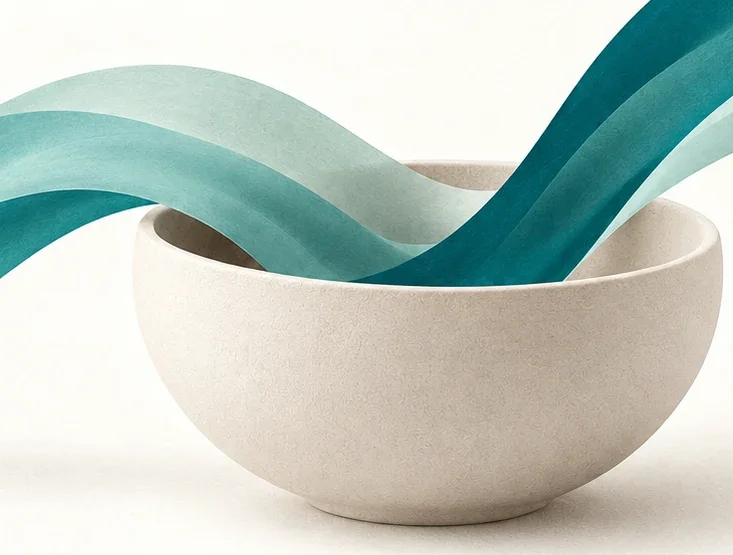 Ivory bowl holding flowing teal ribbons, representing making room for a feeling.