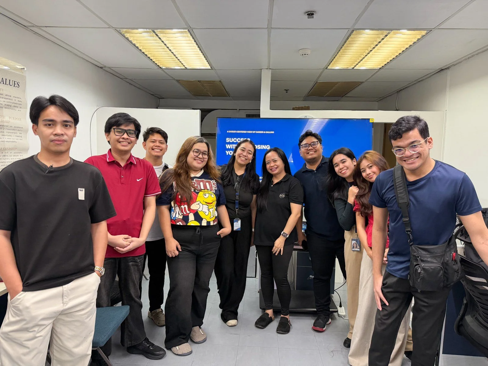 The BGB team gathered in front of a screen reading Success Without Losing Your Self