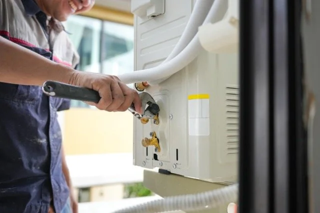 Modern AC condenser installation in Shelby Township Michigan by NEXT Heating & Cooling technician