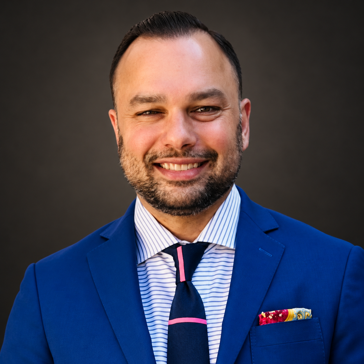 Arjun Dewan, Founder of One Source, in a blue suit