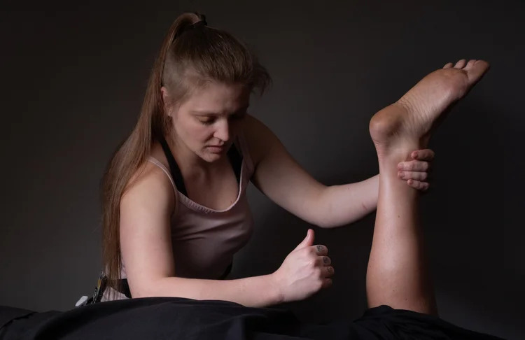 Peyton using Active Release Technique on a client's leg