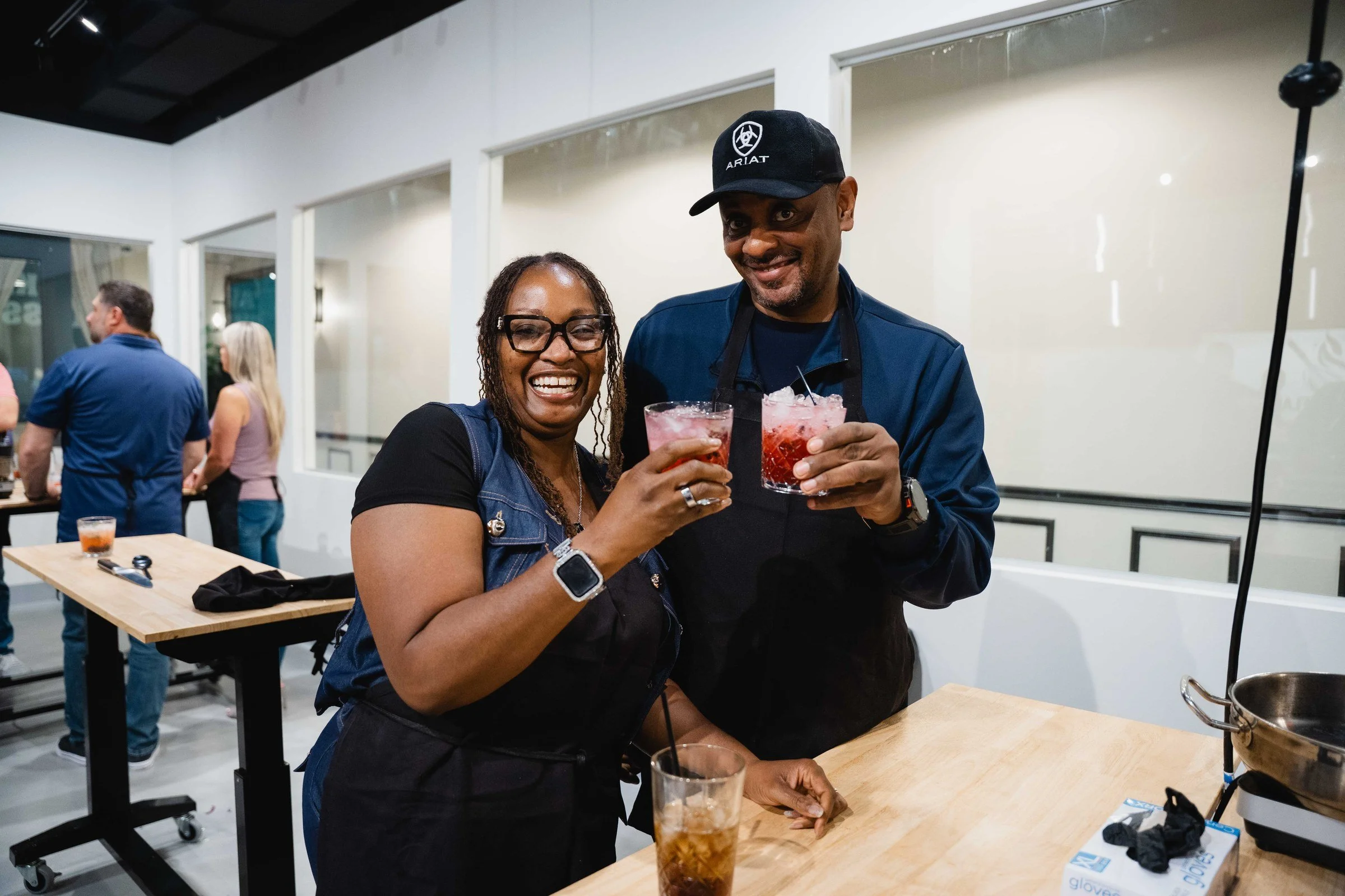 A couple with cocktails at the Whisk and Flame bar