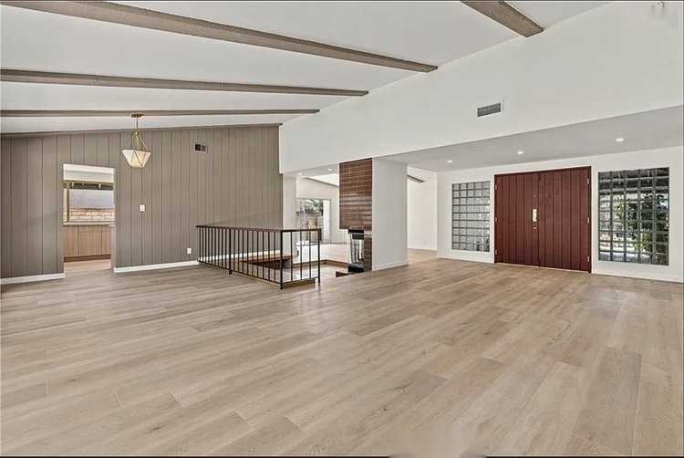 Full home remodel in Los Angeles with open living room, new flooring, and recessed lighting by At Your Service Home Improvement Inc.