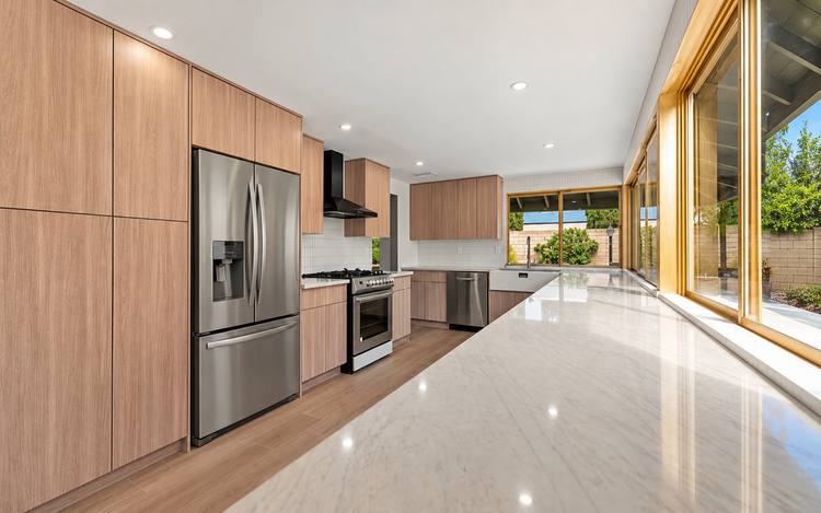 Remodeled kitchen in the San Fernando Valley with custom cabinetry and stone countertops