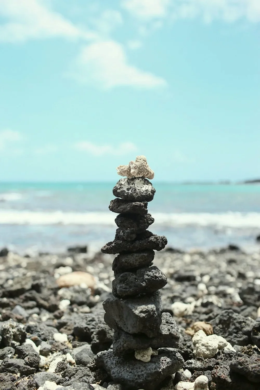 Stacked volcanic stones by the ocean