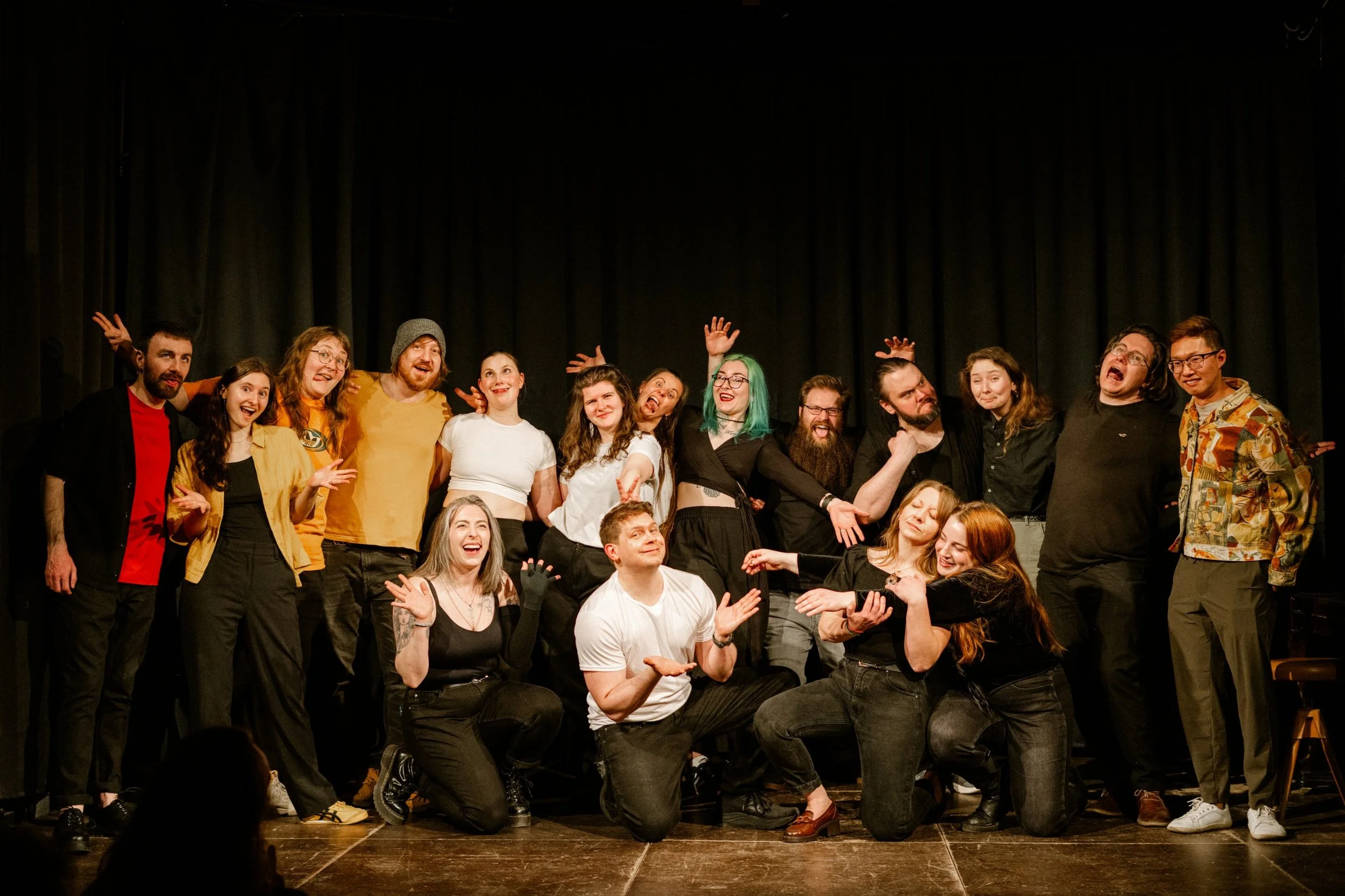 The full cast of a Prague Improv Extravaganza posing together on stage