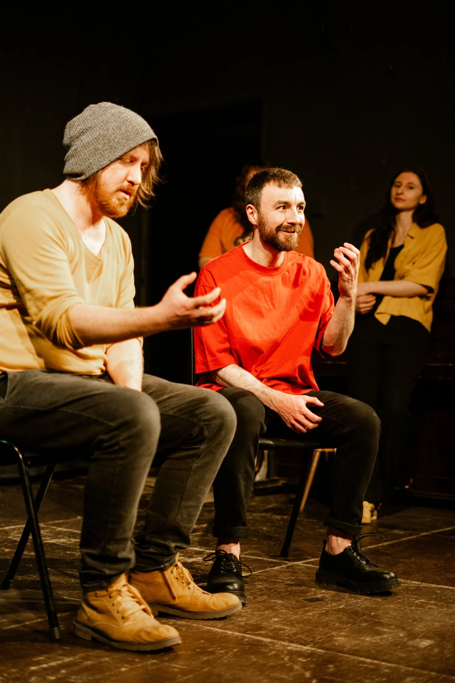 Two improvisers seated mid-scene, Extravaganza 1