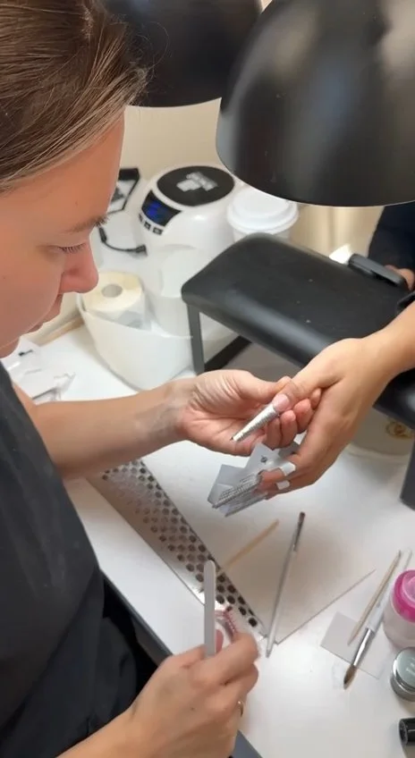Elena Molodykh filing nail shape during gel nail extensions training at Mars Nails School