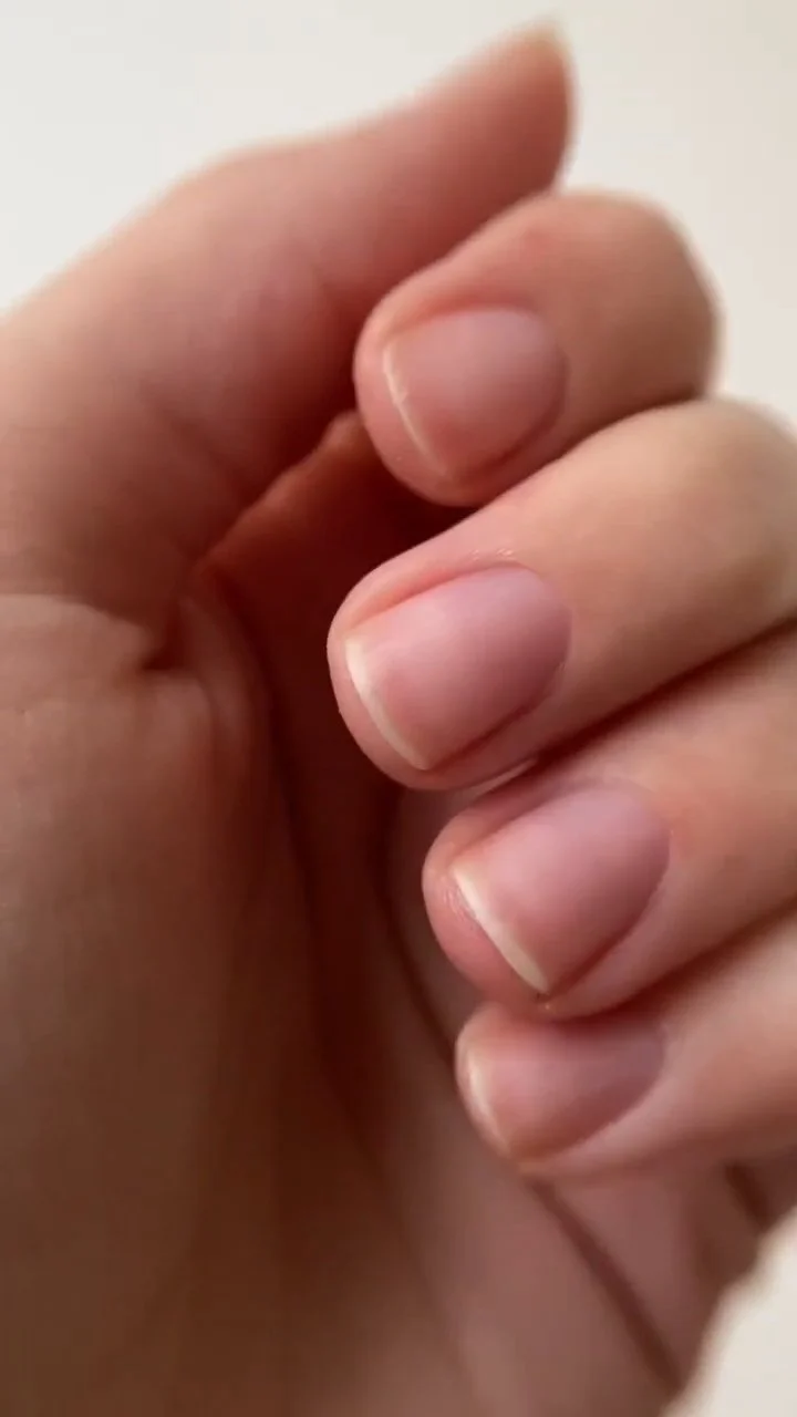 Finished natural nails with nourishing cuticle oil applied