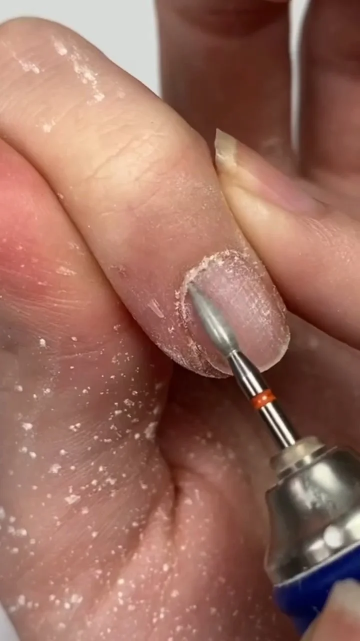 Cleaning the cuticle area with an e-file flame bit