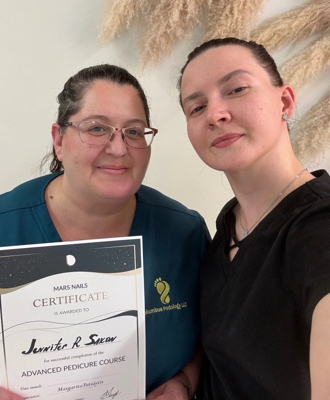 Jennifer R. Saxon with instructor Margarita Yutsaytis after advanced dry pedicure training at Mars Nails School in New York