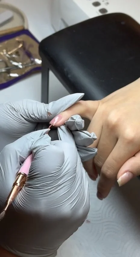 Emilia Dzhafarova applying gel with a brush during advanced manicure training in New York