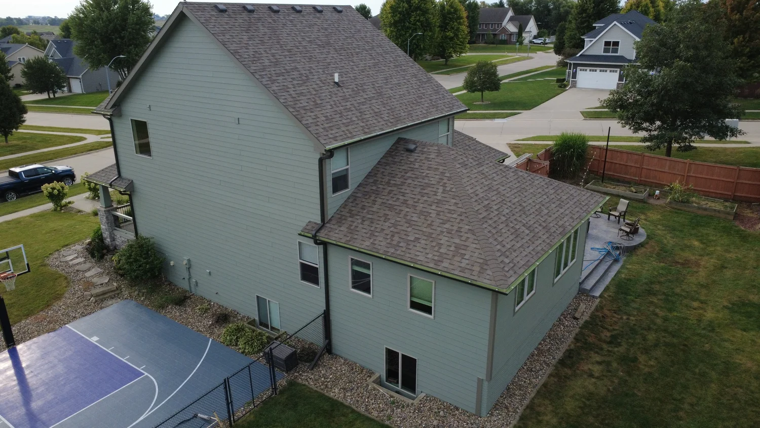 Pale green home exterior painted by Mission Painting in Waukee, Iowa