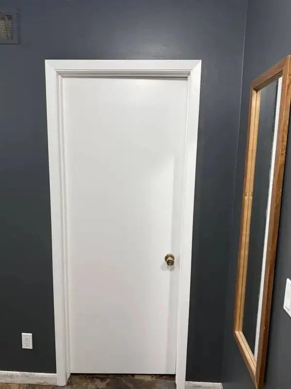 White interior door against a dark wall painted by Mission Painting in Norwalk, Iowa