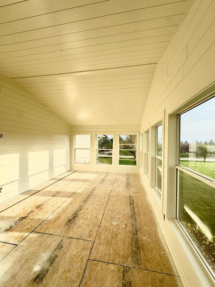Long white shiplap sunroom painted by Mission Painting in Grimes, Iowa