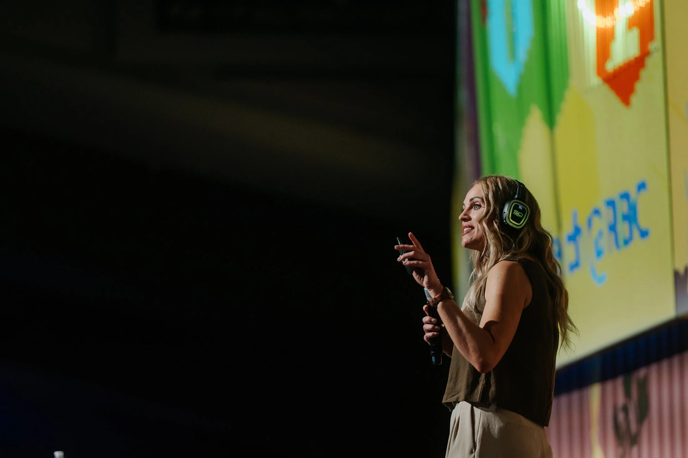 Rebecca Bultsma speaking into a microphone at Upper Bound 2026.