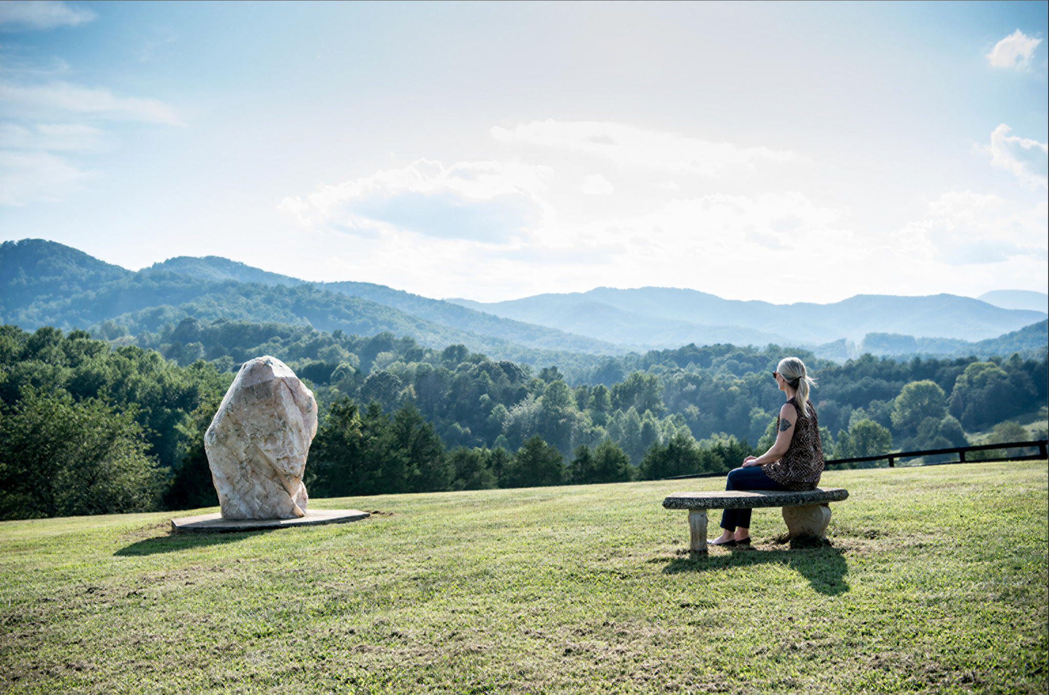 A visitor looking across the landscape at the Monroe Institute