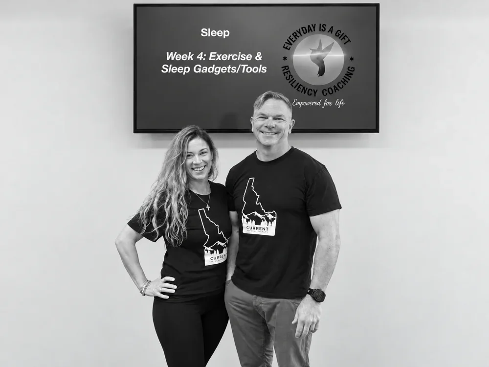 Lou and Trena together in black T-shirts at a sleep workshop, in black and white