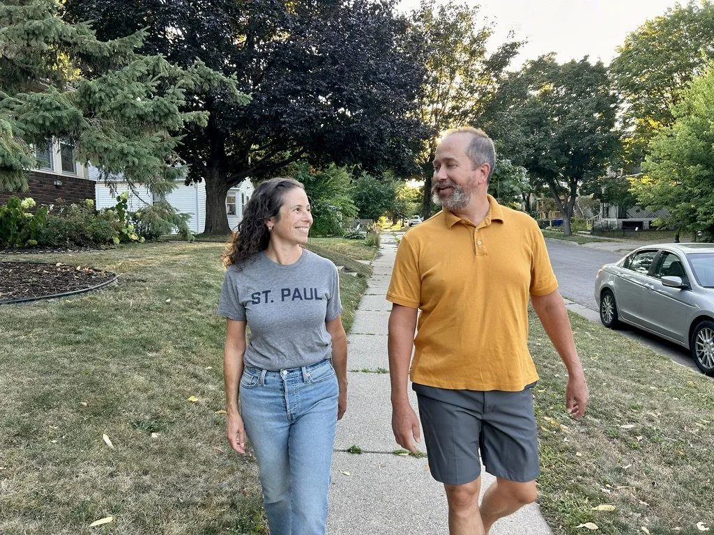 Rebecca Noecker and her husband Shane walking on a West Side sidewalk