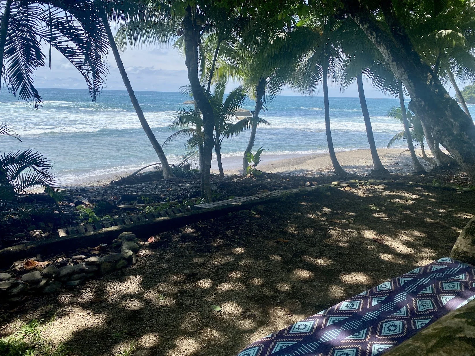 Shaded seating by the ocean at Selvana