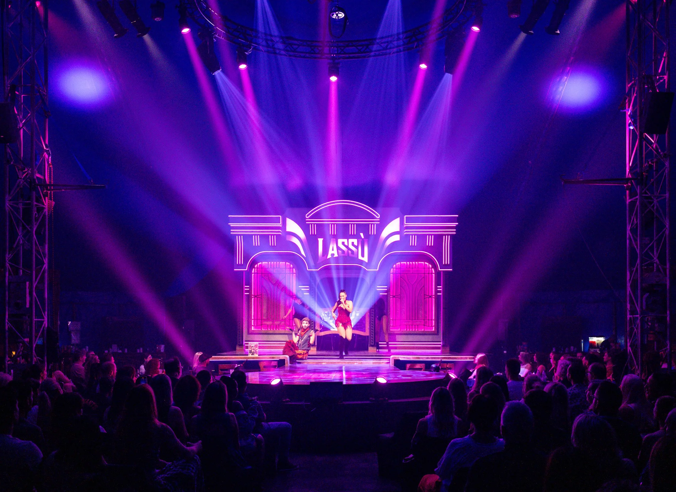 LASSU Cosmic Cabaret stage lit in purple and pink