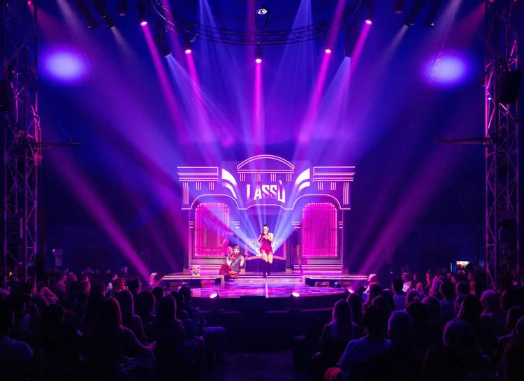 LASSU Cosmic Cabaret stage lit in purple and pink