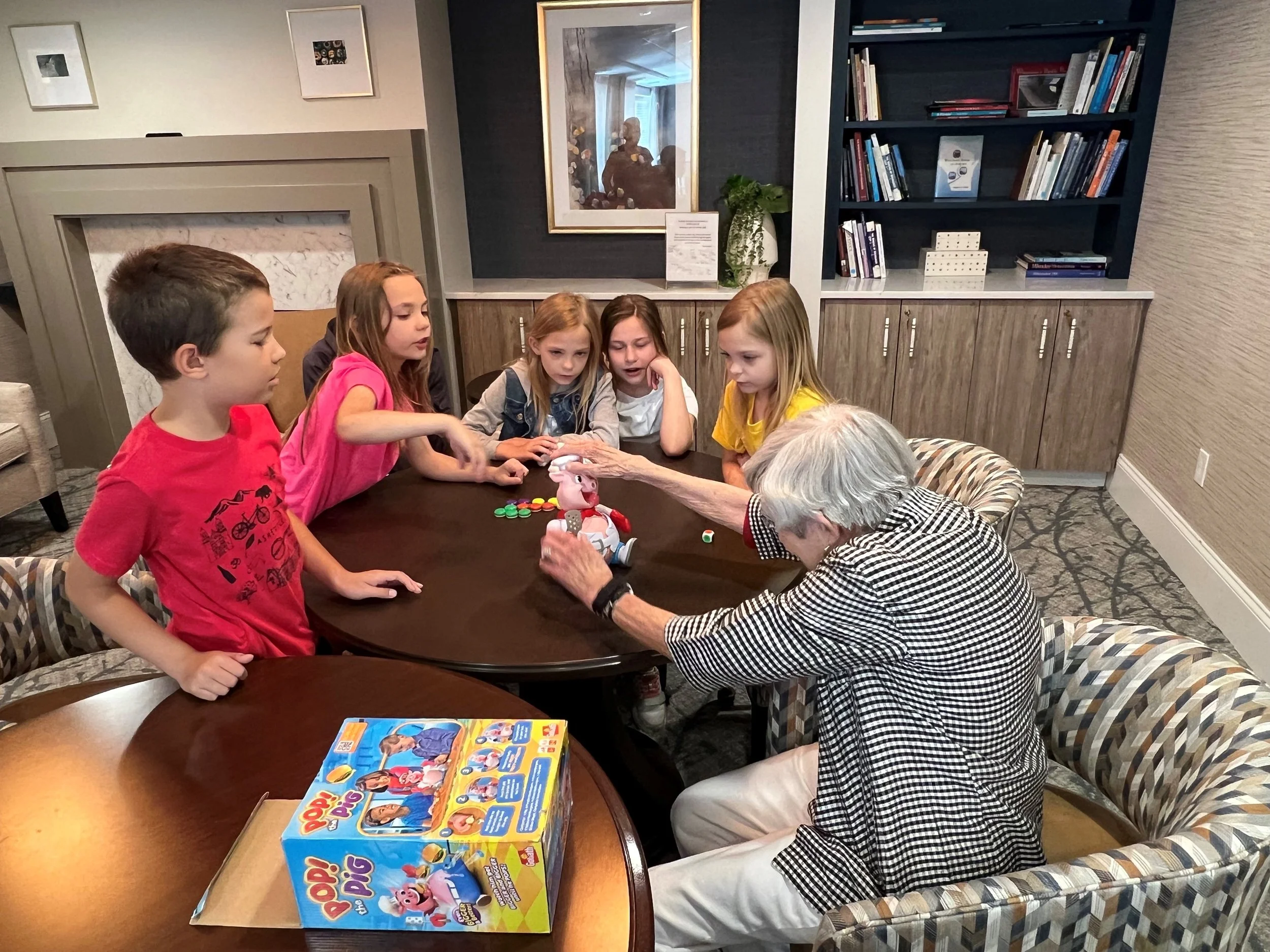 Members gathered around a table for board games and fellowship