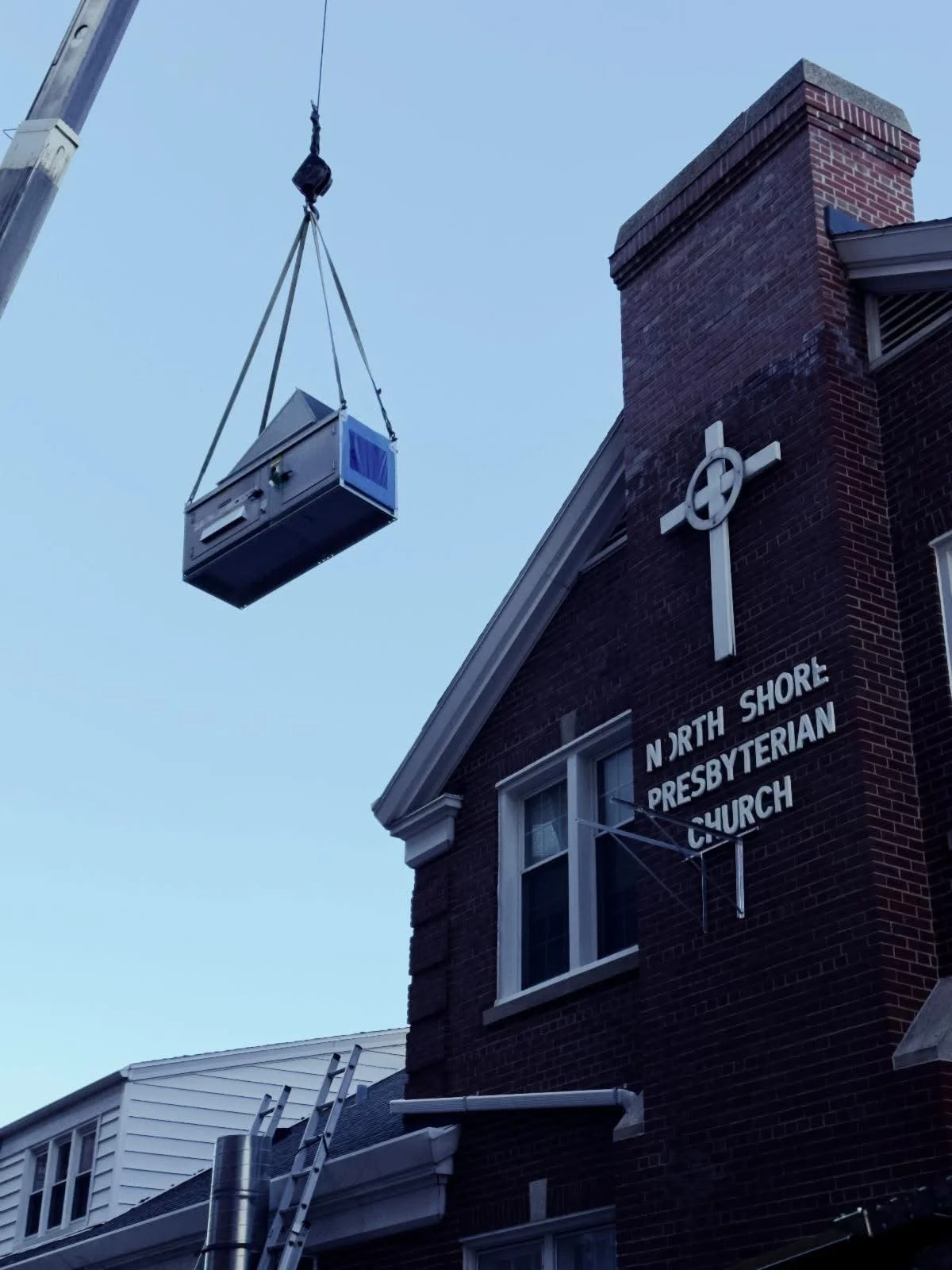 Equipment lifted into place beside the church