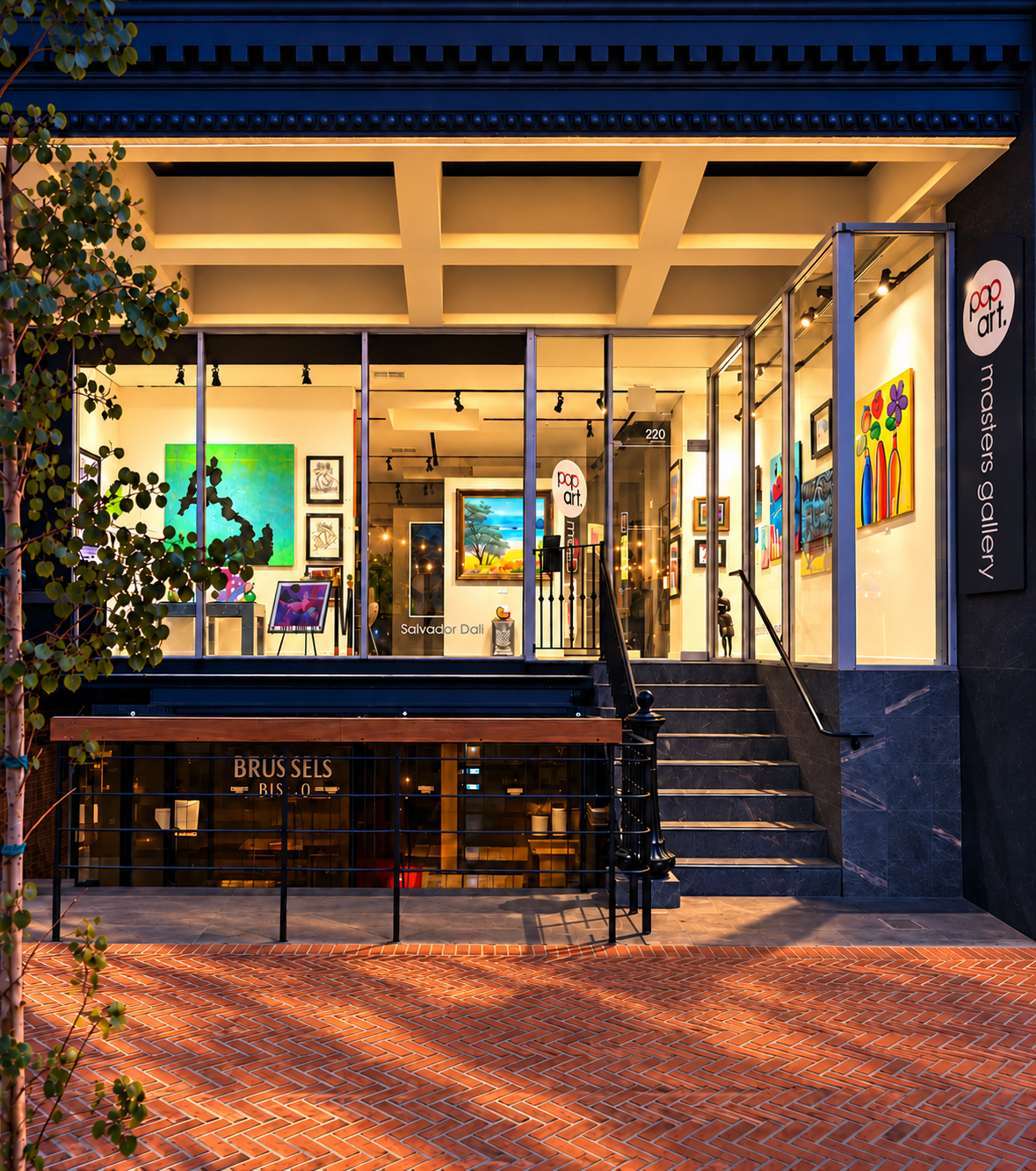 Pop Art Masters gallery at blue hour with warm golden brick pavers; retouched photograph
