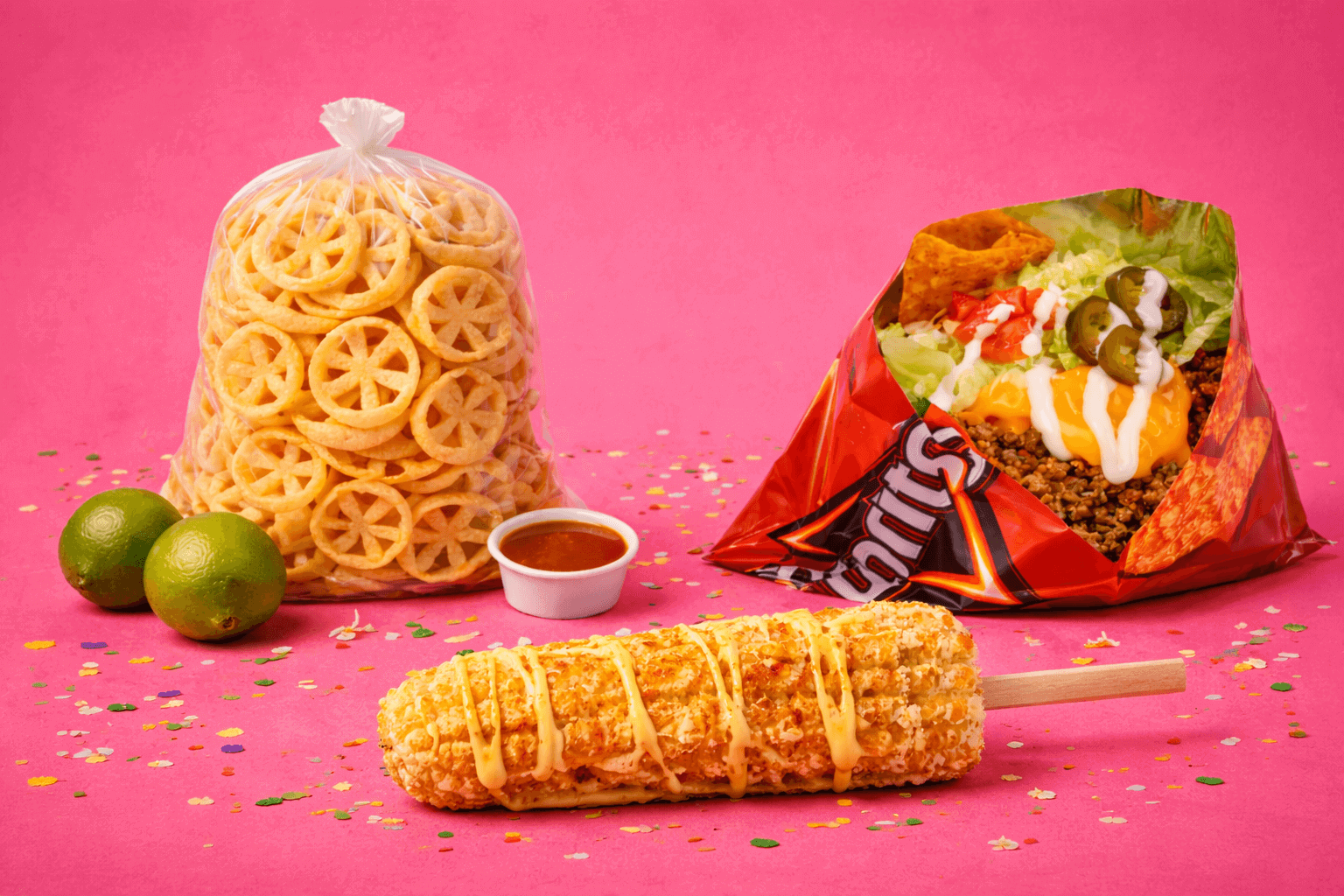 Authentic Mexican street snacks at La Rosita in South Bend, Indiana including elote, a Doritos walking taco, and rines with lime and salsa.