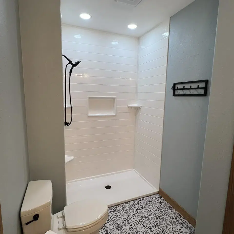Finished walk-in shower with modern fixtures