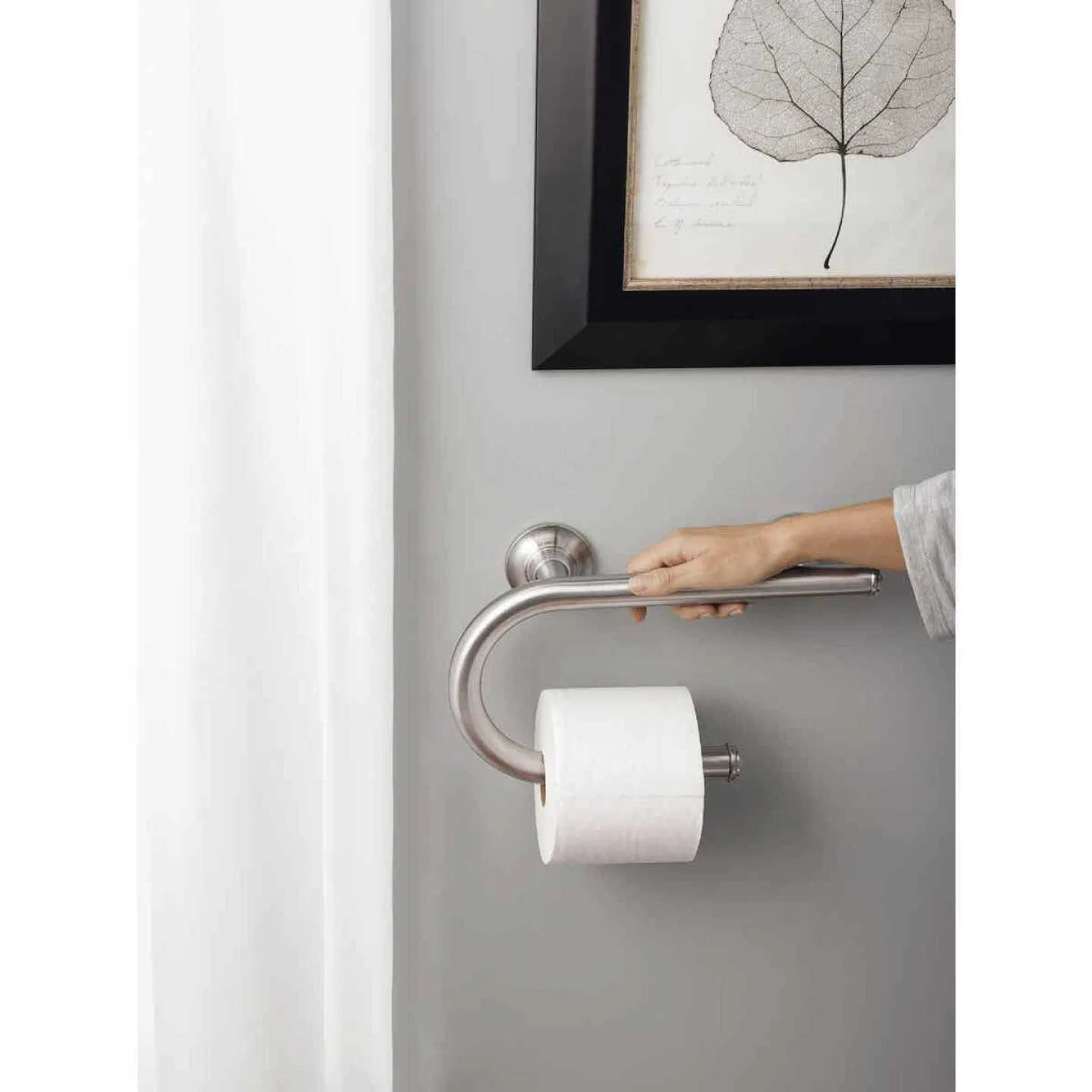 Grab bar installed beside a toilet, positioned for standing up
