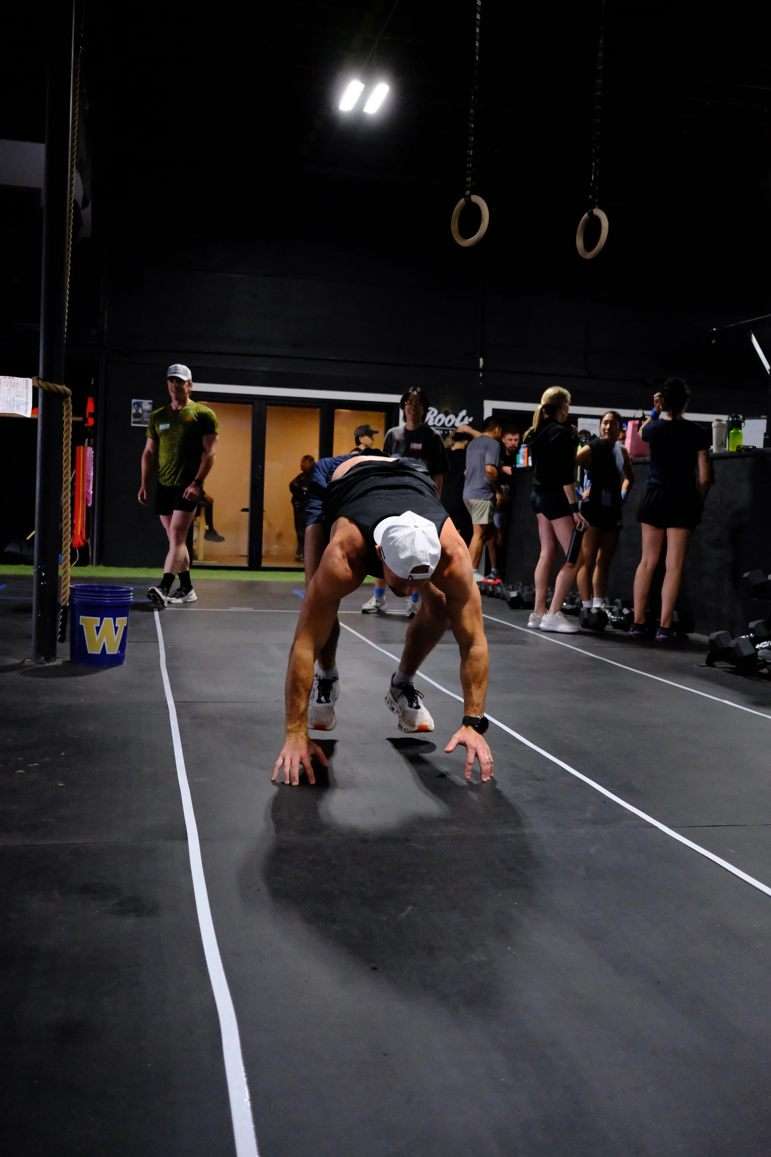 Burpee broad jumps down the marked lane at Root Strength Seattle