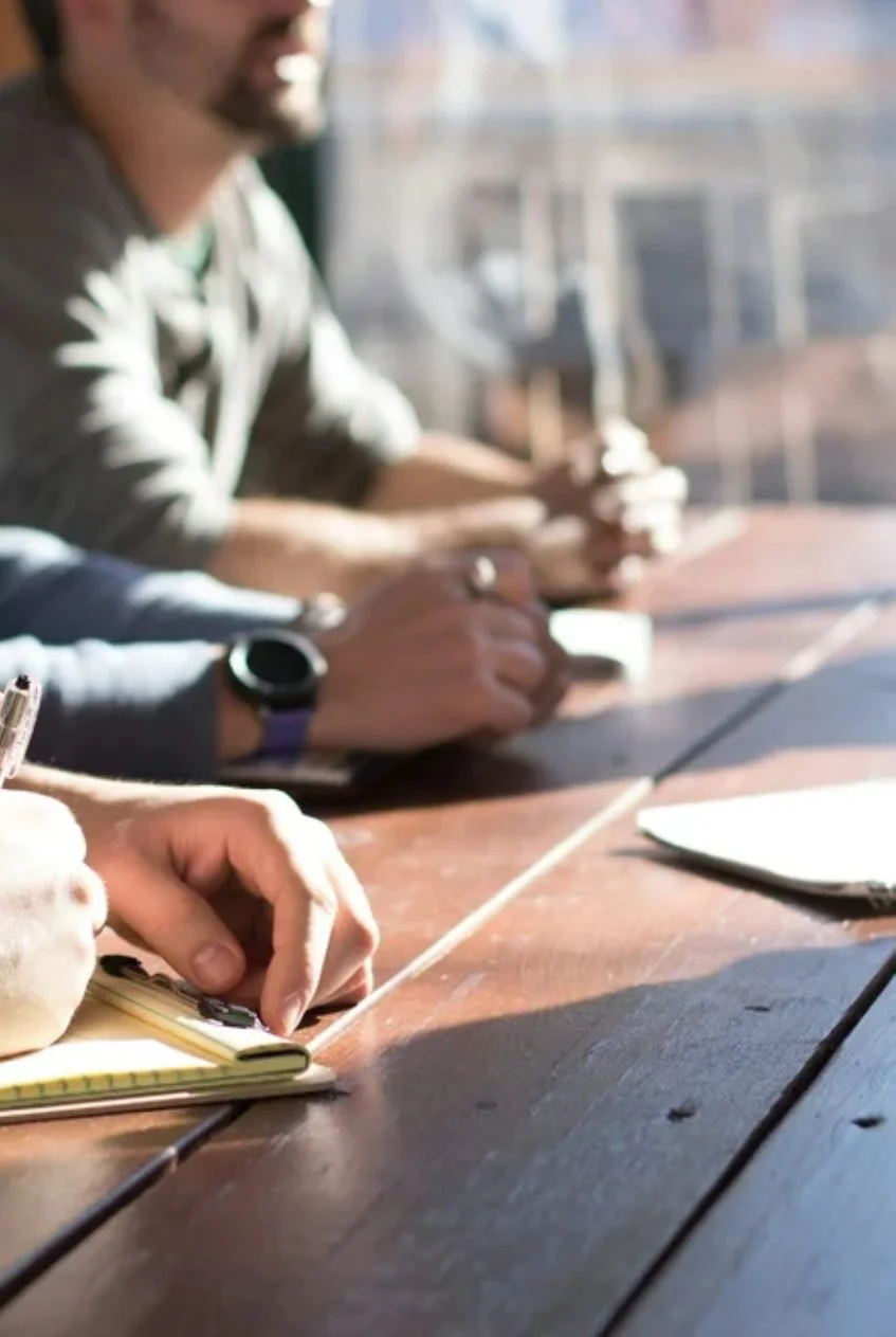 Founders working together around a table with notebooks