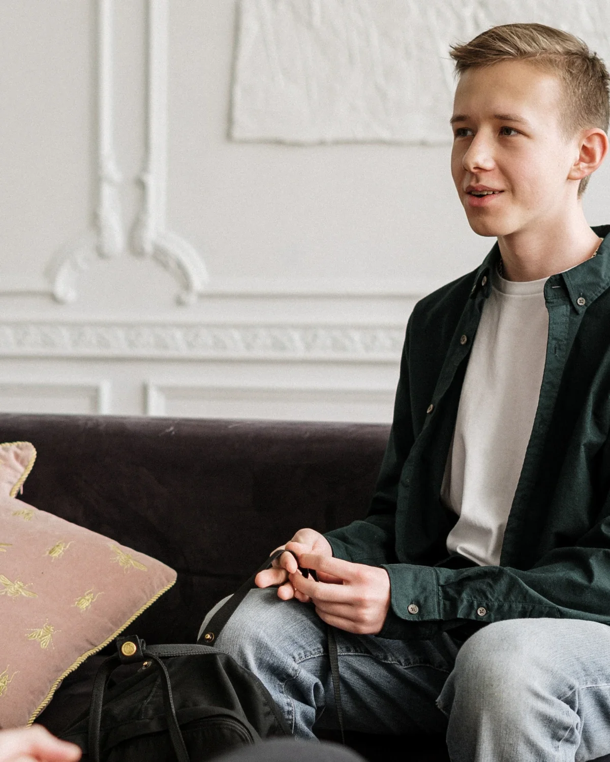 A boy looking toward an adult during a conversation