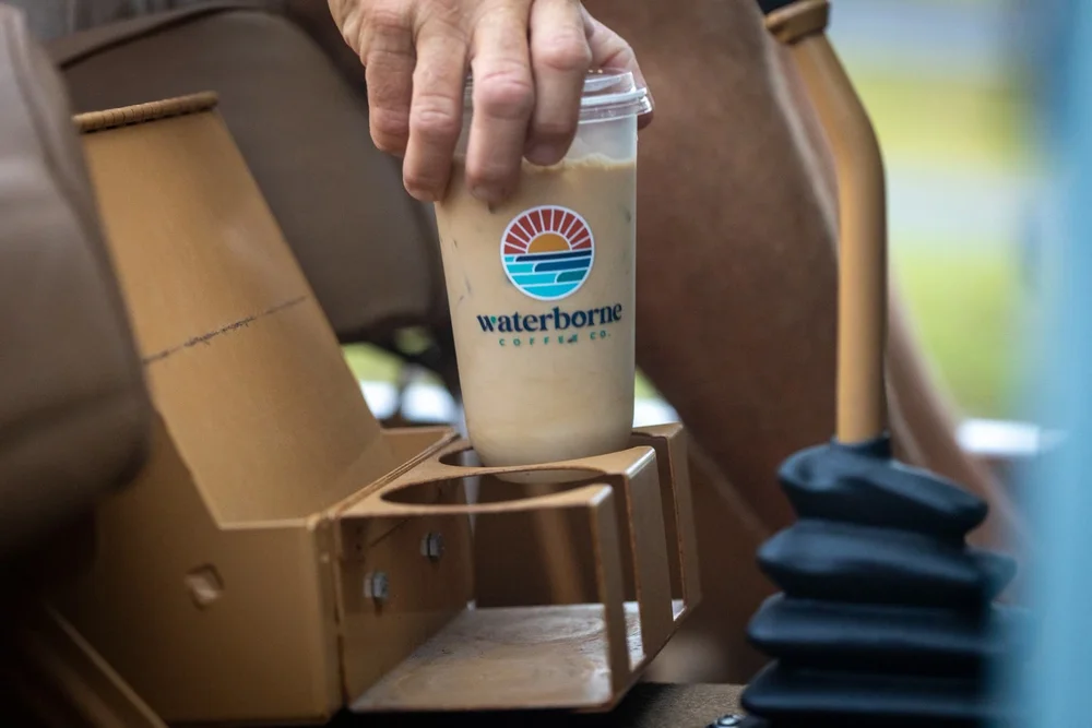 Iced latte in a Waterborne cup in a Jeep cup holder