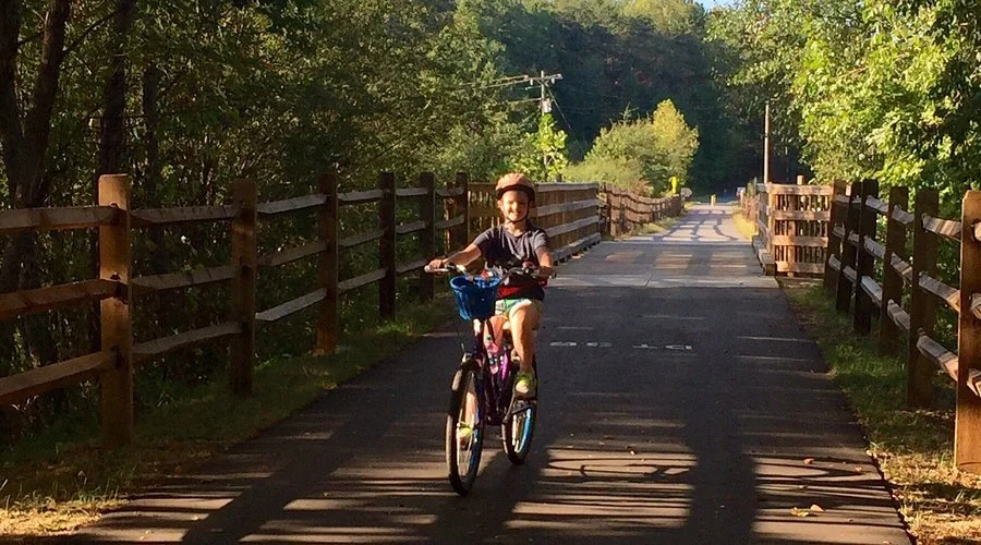 The 7.5-mile paved 'rails-to-trails' path of the Doodle Trail, ideal for family cycling and running just a short drive from Riverdaze.