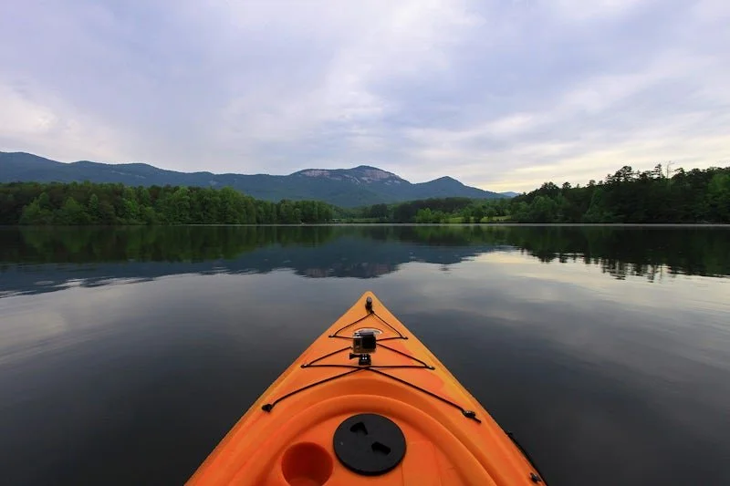 Iconic mountain reflections on the calm waters of Lake Oolenoy inside Table Rock State Park, located minutes from the Riverdaze upscale basecamp.