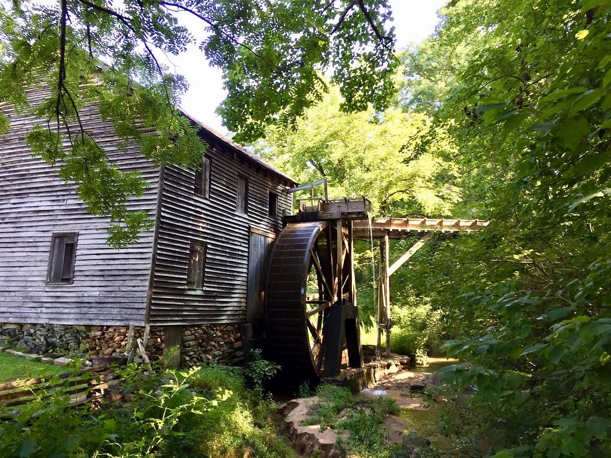 The operational water-powered grist mill at Hagood Mill Historic Site, a portal to local history and ancient petroglyphs near Riverdaze.