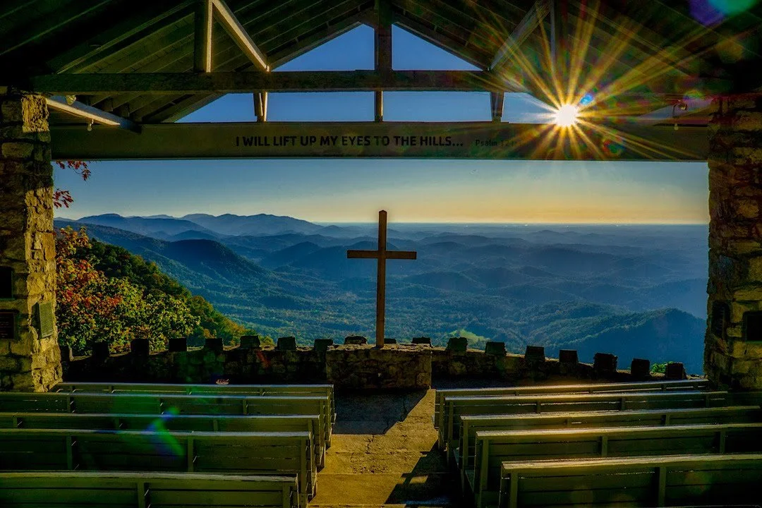 An awe-inspiring sunrise over the mountains at Pretty Place Chapel, a spiritual and scenic landmark just a short drive from Riverdaze.