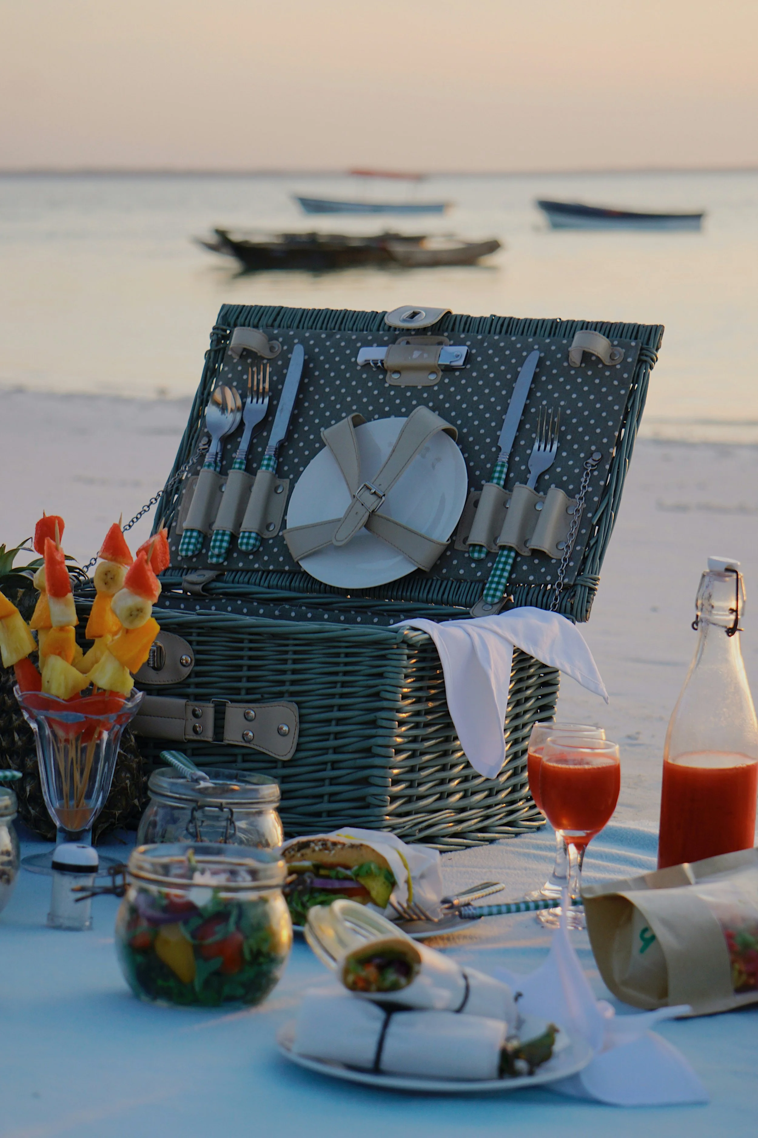 Styled Naru Zanzibar beach picnic with cushions and luxury table decor
