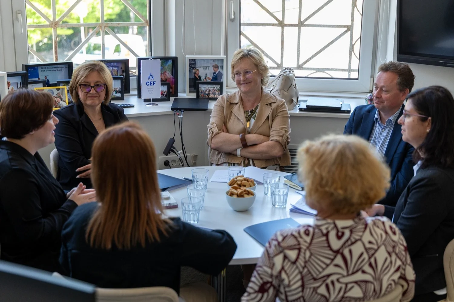 Participants in discussion around an office table during a visit to CEF.