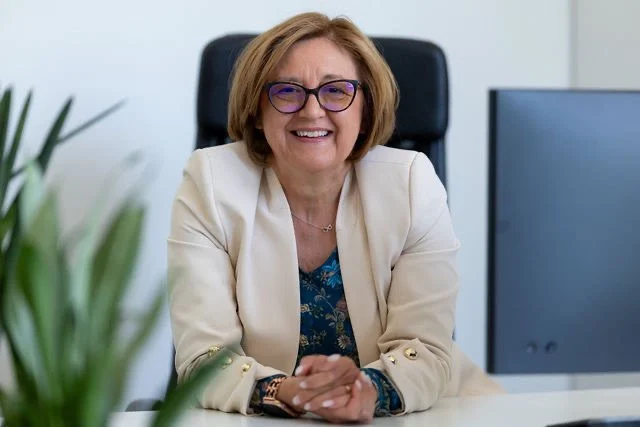 CEF director Jana Repanšek seated at her office desk.