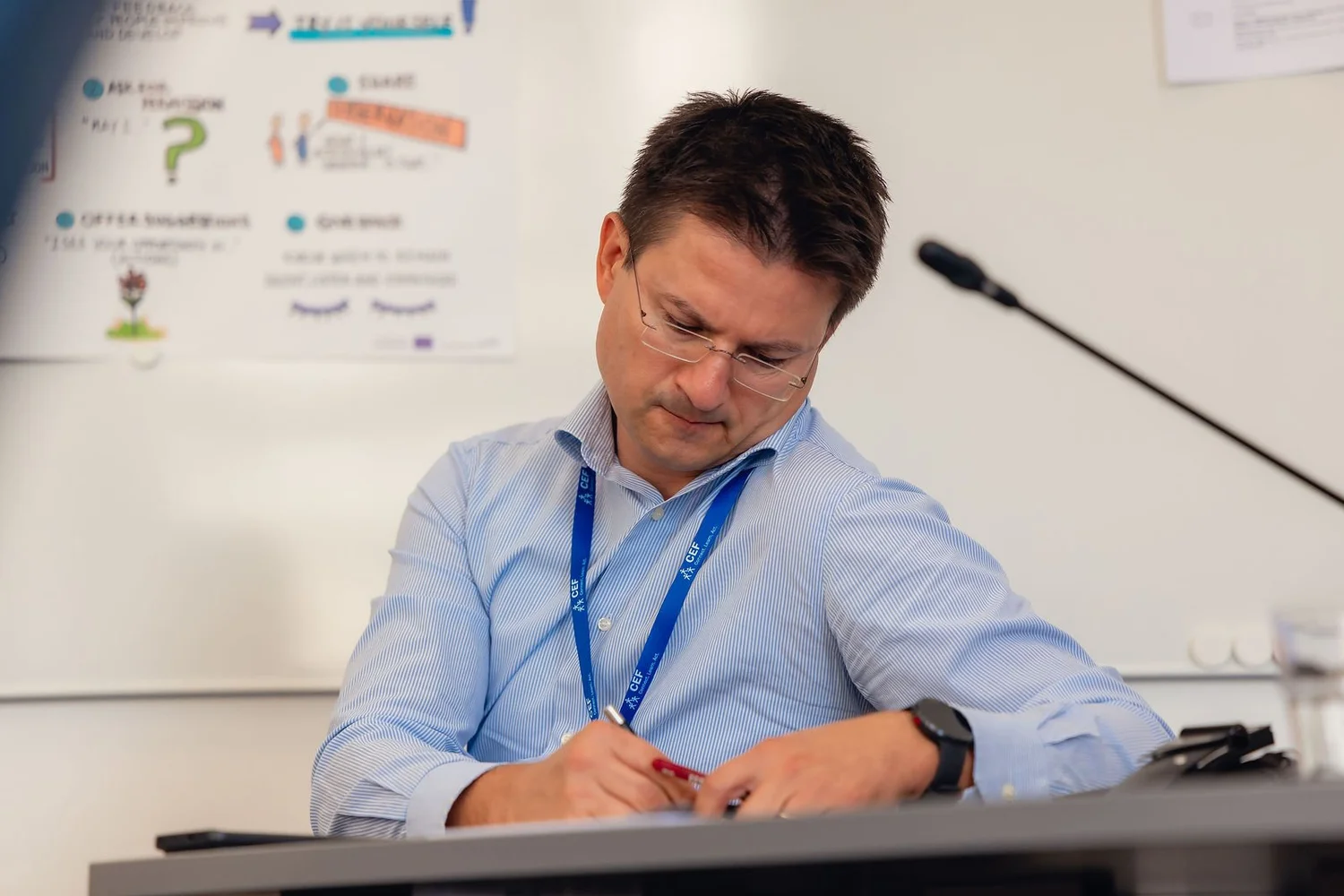 A participant writes notes during a CEF training session.