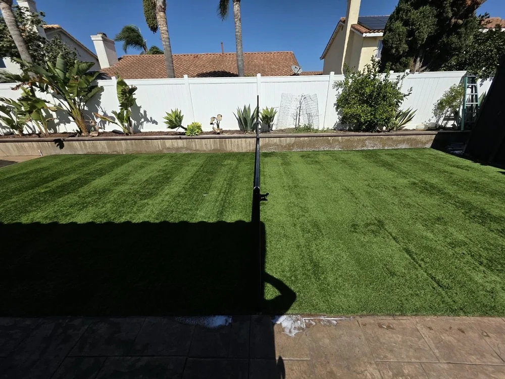 Fenced backyard artificial turf after a Hydroforce cleaning