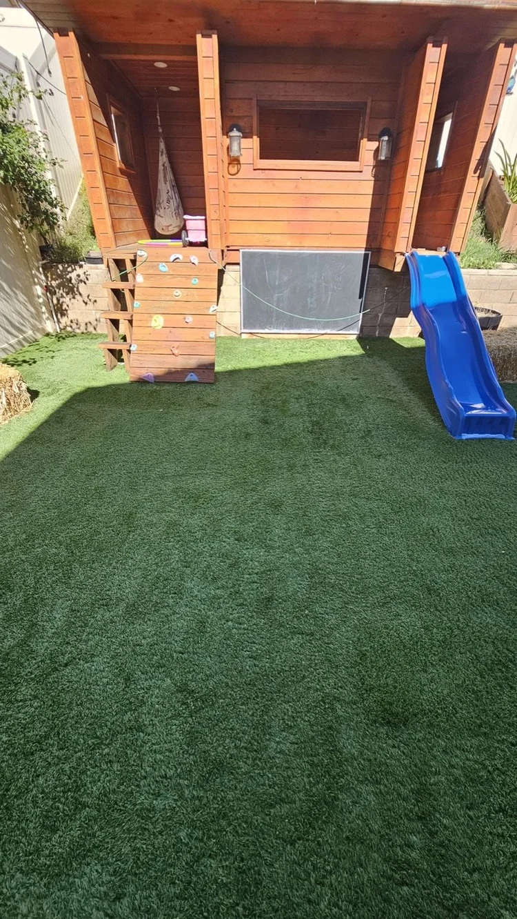 Turf in front of a kids&rsquo; playhouse after a Hydroforce clean