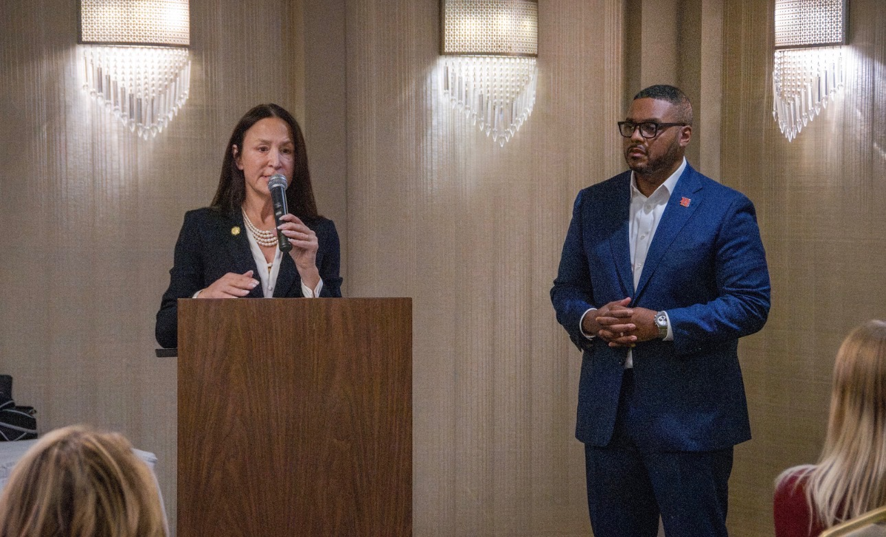 Michelle Milan McFall speaking at a podium