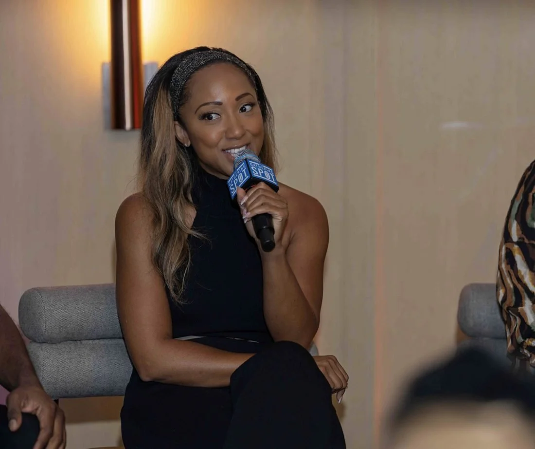 Aisha speaking on a panel