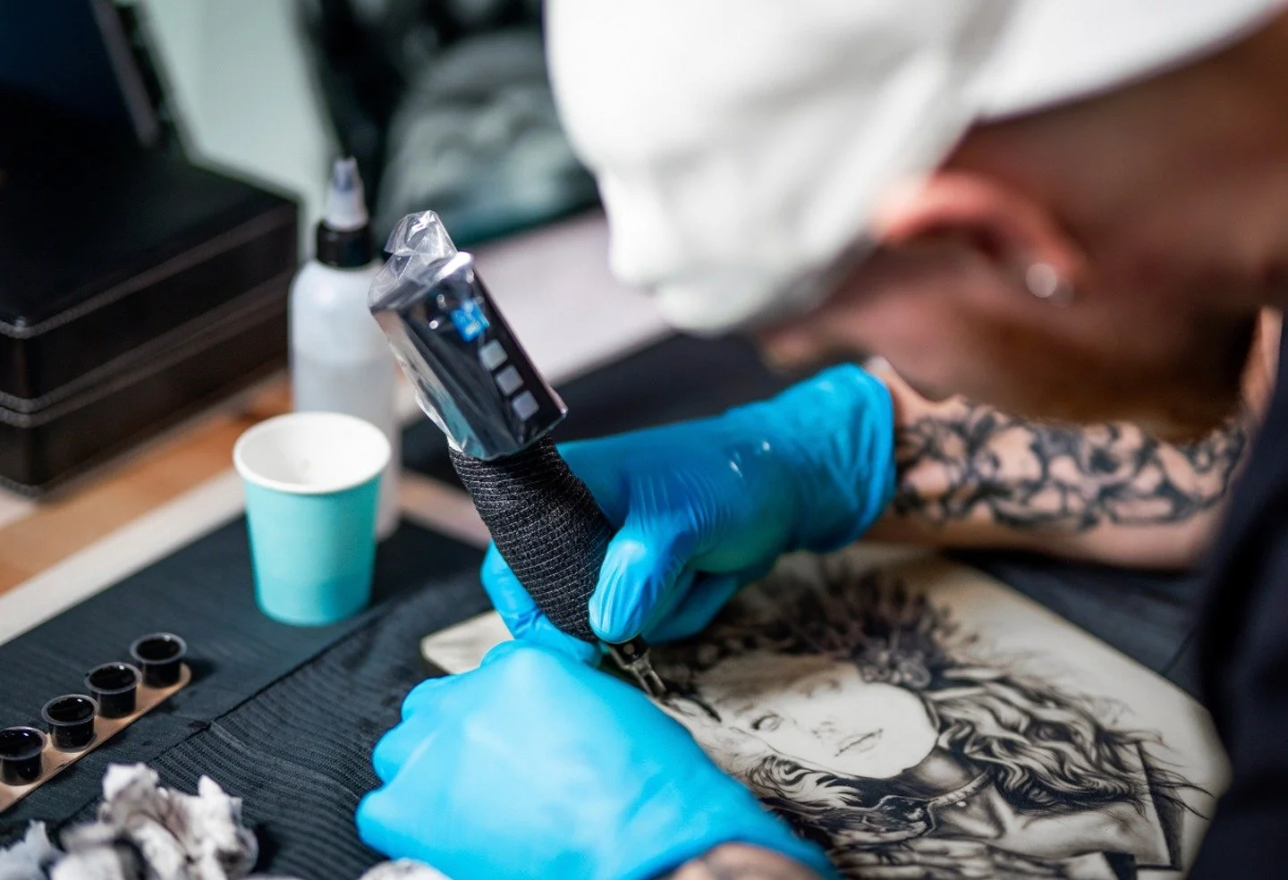 Tattoo instructor teaching a student