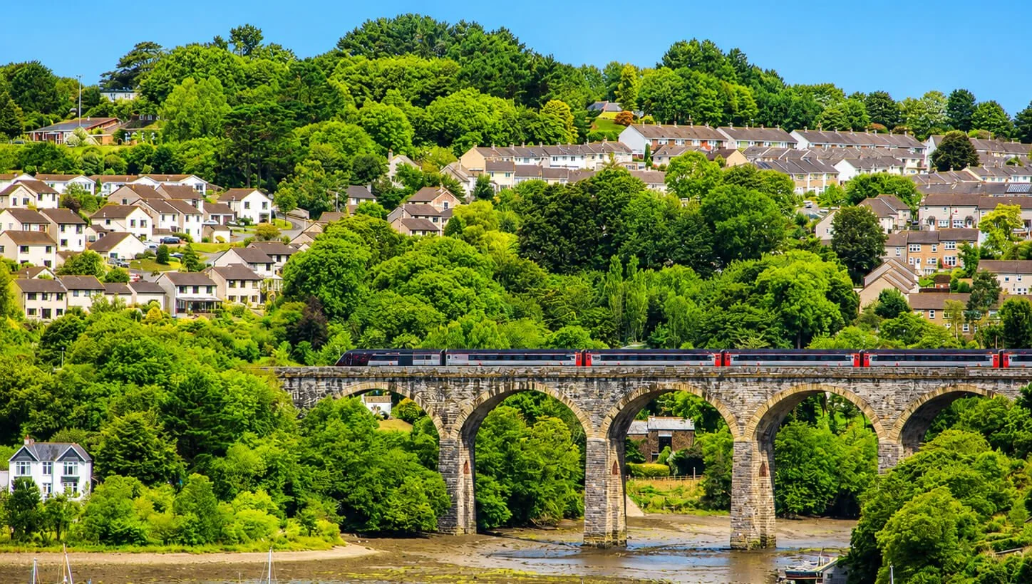 View across Saltash and the Tamar Valley, showing residential streets on the hillside and the railway viaduct.
